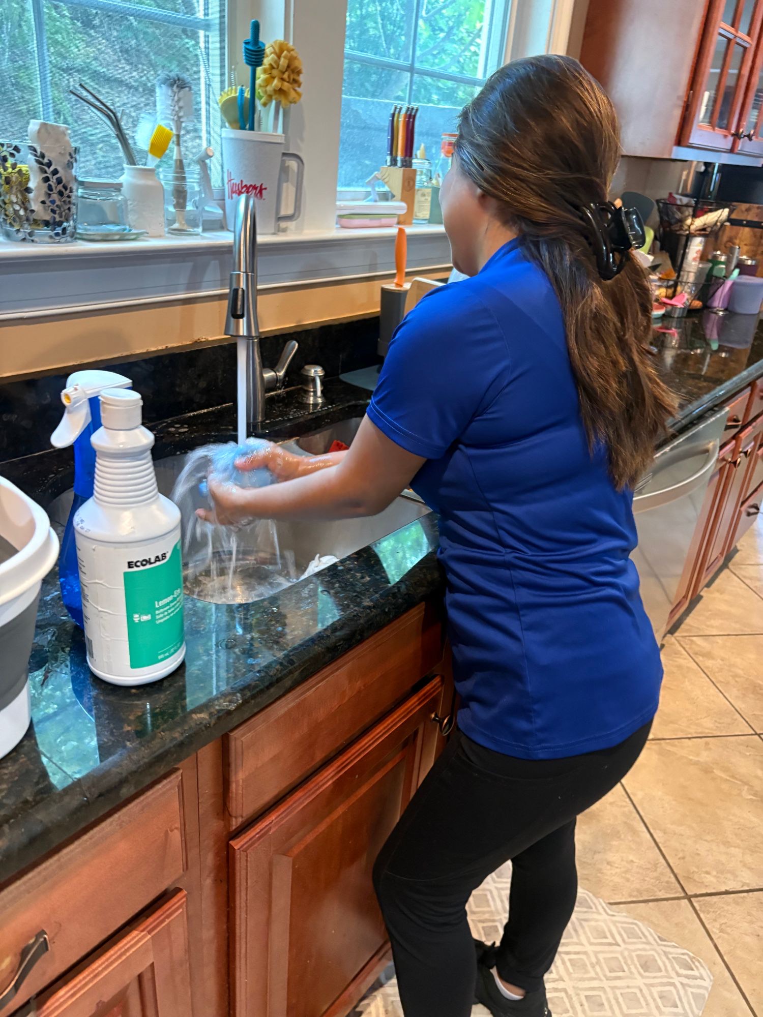 Judy cleaning a kitchen sink in Woodbridge, VA
